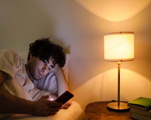 A phone screen dimmed down during nighttime reading
